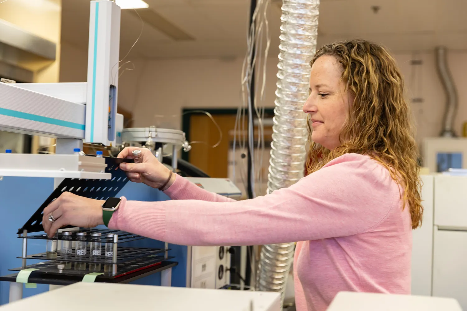 Scientist reviews lab equipment for an experiment.