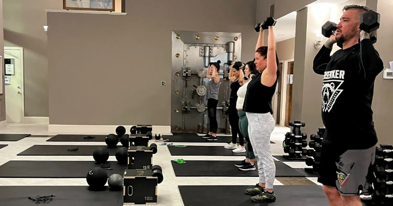 Men and women take a weight-lifting class at Frostburg Fitness's pop-up location.