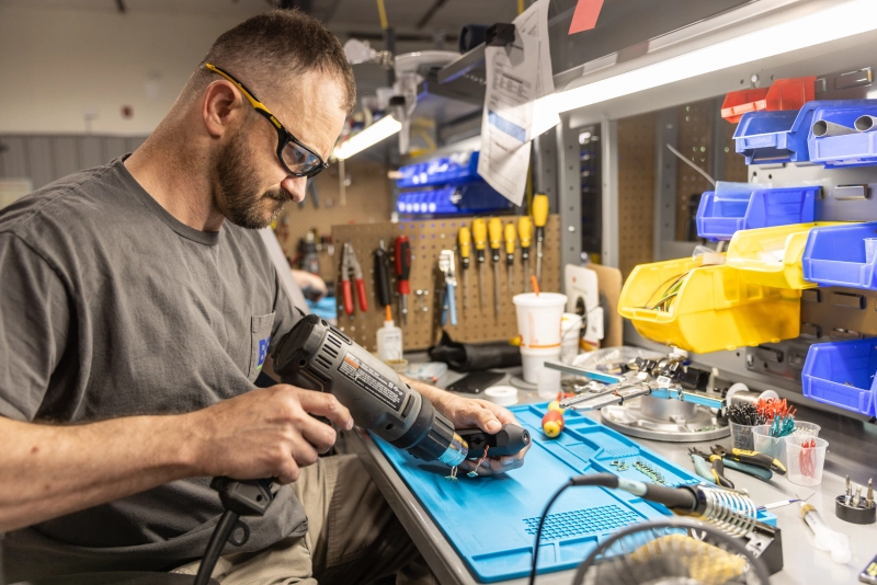 Technician building a sensor.