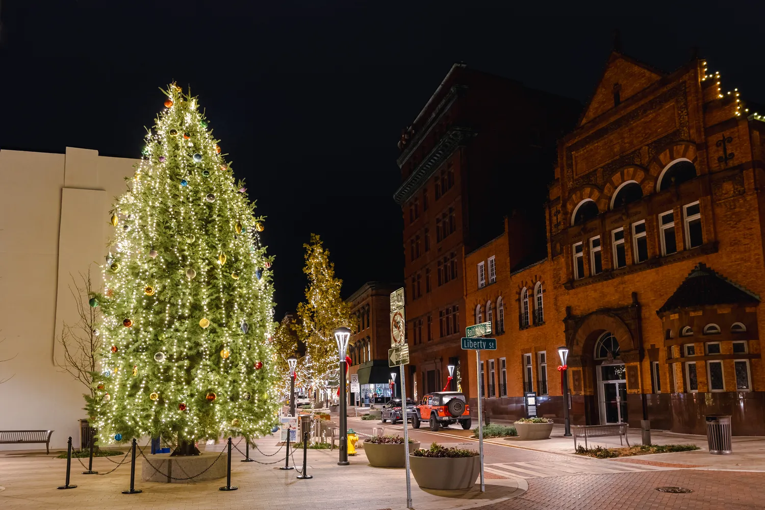 Downtown Cumberland during the holidays with a lit tree in the foreground.