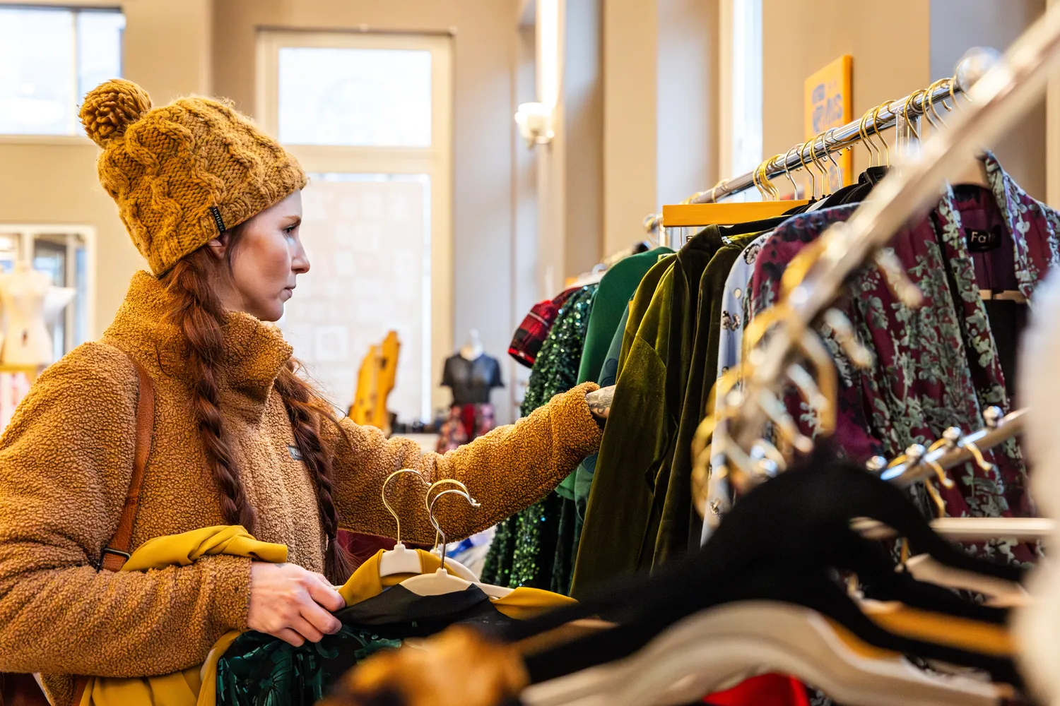 Woman in yellow hat shops at a local store.