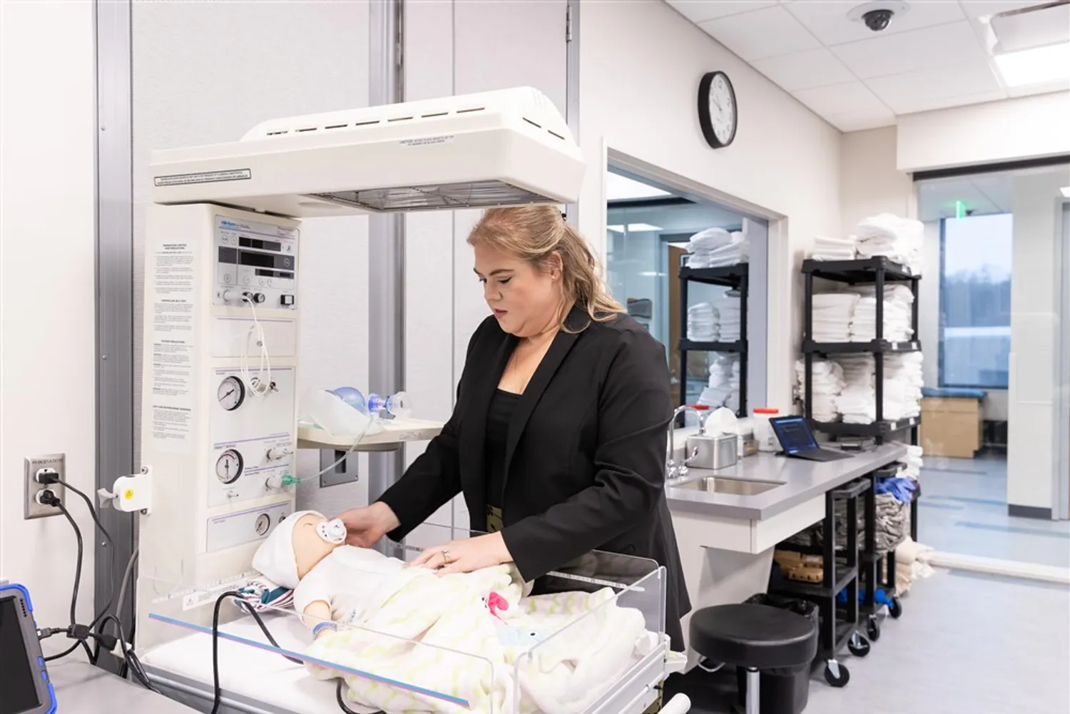 A woman stands in one of Frostburg State University's patient care simulator labs.