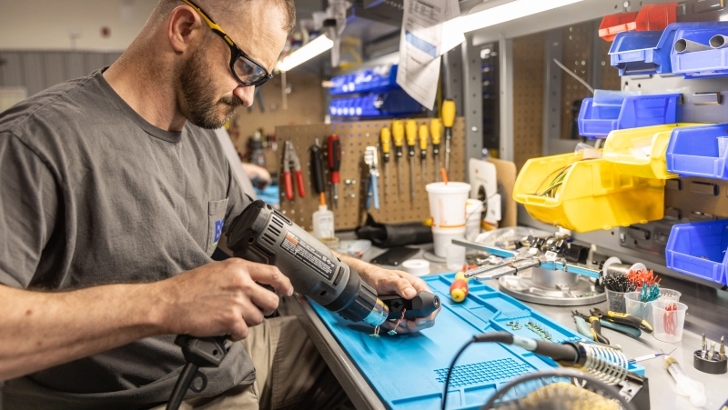 Technician building a sensor.